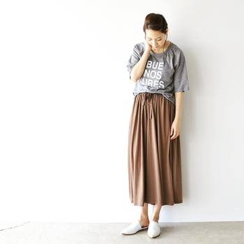 ロングスカートにゆったりしたTシャツの裾を部分的にタックイン。白のバブーシュサンダルを合わせて爽やかな抜け感を出しています。